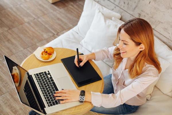 Young woman designing on a laptop in a cafe