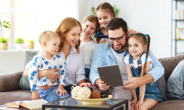 large family mother, father and four children with tablet computer at home