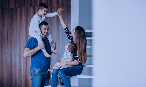 Young family with their little son at home having fun