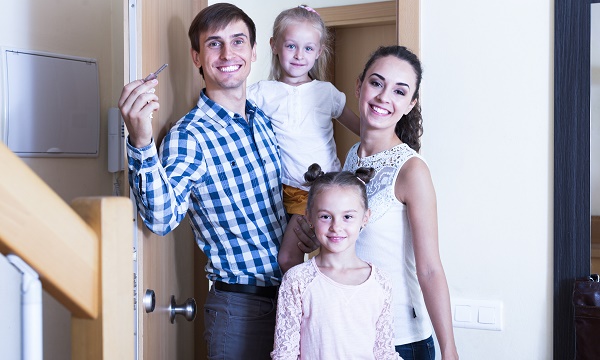 family standing at doorway